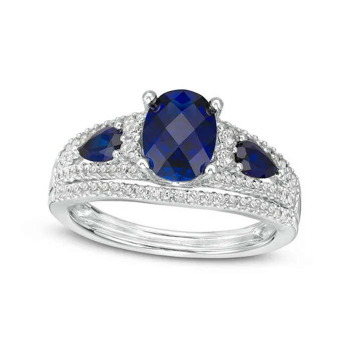 Oval LabCreated Blue Sapphire and 050 CT TW Diamond Three Stone Ring in Solid 10K White Gold Goldia Rings